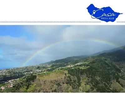 a rainbow in the sky over a city at Holiday home Casa Brisa Mar in Prazeres in Prazeres