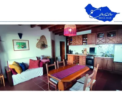 a living room with a table and a couch at Holiday home Casa Brisa Mar in Prazeres in Prazeres