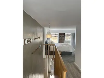 a staircase leading to a bedroom with a bed at Fisherhouse23 Comfortable holiday residence in Câmara de Lobos