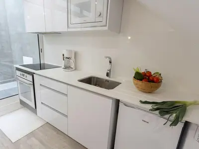 a white kitchen with a sink and a bowl of fruit at Fisherhouse23 Comfortable holiday residence in Câmara de Lobos