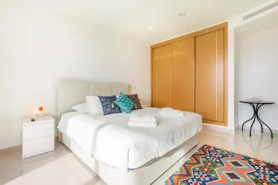 a bedroom with a white bed with a large window at Casa Lilou - Luxury Oceanview Penthouse in Lagos