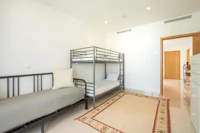 a bedroom with two bunk beds and a rug at Casa Lilou - Luxury Oceanview Penthouse in Lagos