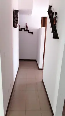 a hallway with white walls and a tile floor at Madeira property in Câmara de Lobos