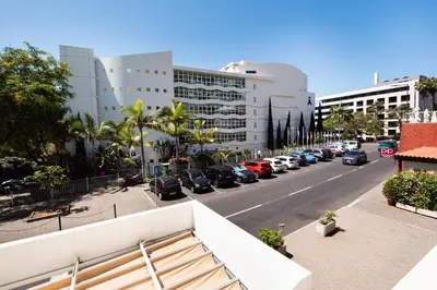 a city street with cars parked in a parking lot at Monumental Lidoview in Funchal