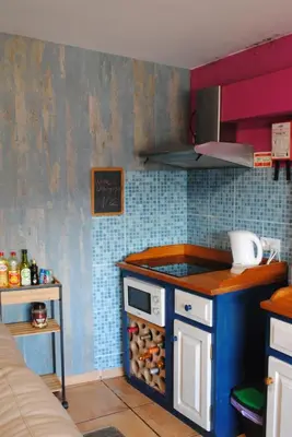 a kitchen with a stove and a counter top at Casa da Adega in Machico