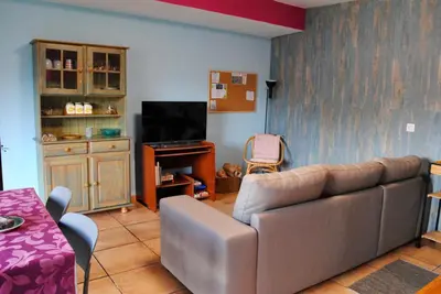 a living room with a couch and a television at Casa da Adega in Machico