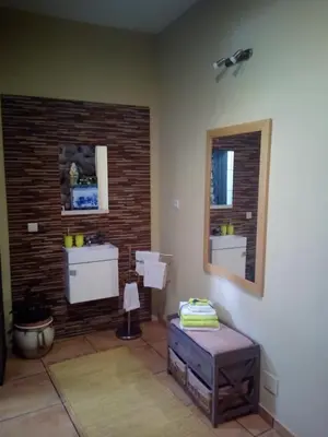 a bathroom with two sinks and a mirror at Casa da Adega in Machico