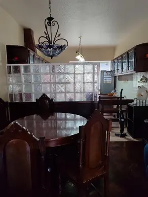 a kitchen with a dining room table and a chandelier at casa na Torre in Machico