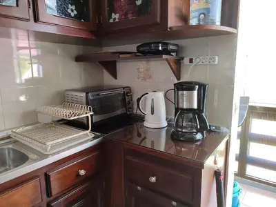 a kitchen counter with a coffee maker and a microwave at casa na Torre in Machico