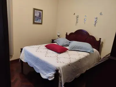 a bedroom with a bed with a red pillow on it at casa na Torre in Machico