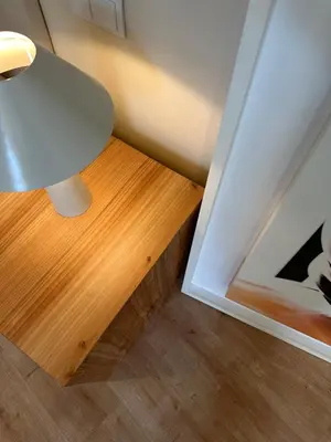 a table with a lamp next to a wooden floor at Downtown collection apartments II in Funchal