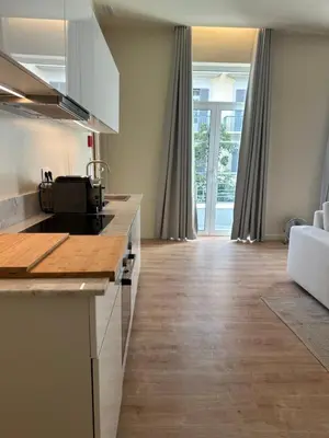 a kitchen with a counter and a living room at Downtown collection apartments II in Funchal