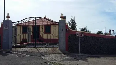 a building with a gate in front of it at Herdade do Pedregal in Ponta do Pargo