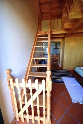 a wooden staircase in a room with a stair case at Herdade do Pedregal in Ponta do Pargo