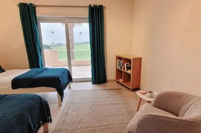 a bedroom with a bed and a couch and a window at Deluxe 3 bedroom townhouse - Quinta da Atalaia in Lagos