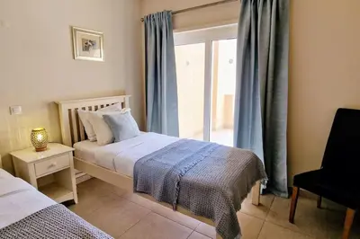 a bedroom with a bed and a window at Deluxe 3 bedroom townhouse - Quinta da Atalaia in Lagos