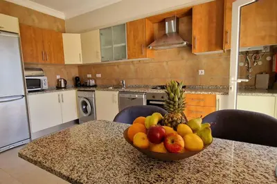 a bowl of fruit on a table in a kitchen at Deluxe 3 bedroom townhouse - Quinta da Atalaia in Lagos