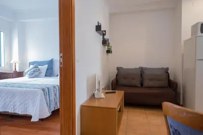 a bedroom with a bed and a couch at Apartments Madeira Old Town in Funchal