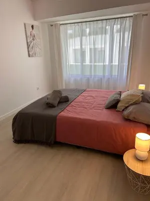 a large bed in a room with a large window at Lido Branca by Olá Madeira in Funchal
