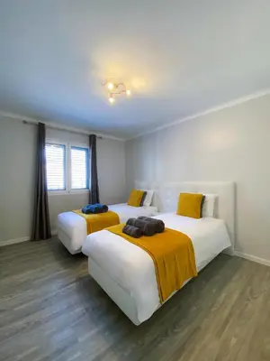 two beds in a hotel room with two bedsvisor at Village Square Coastal Apartment 2F in Machico