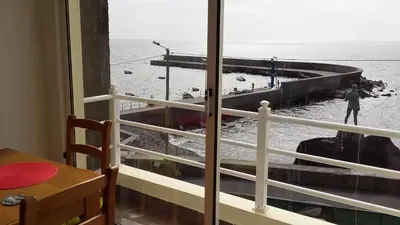 a view of the ocean from a room with a window at Harbour House in Paul do Mar