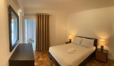 a hotel room with a bed and a mirror at Discovery 1 in Machico