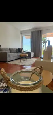 a living room with a couch and a table at Discovery 1 in Machico