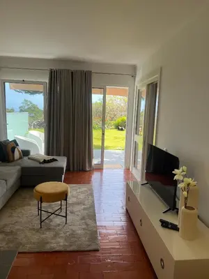a living room with a couch and a tv at Discovery 1 in Machico