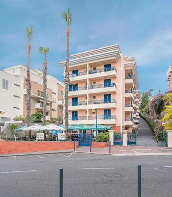 a balcony with two chairs and a table with drinks at Lido Costa do Sol in Funchal