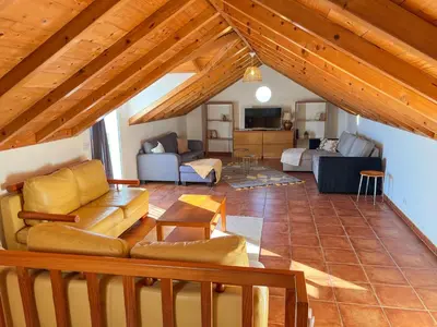 a living room with a couch and a table at Calheta Bay View House - Family and Group Residence in Arco da Calheta