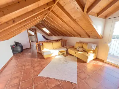 a living room with a couch and a rug at Calheta Bay View House - Family and Group Residence in Arco da Calheta