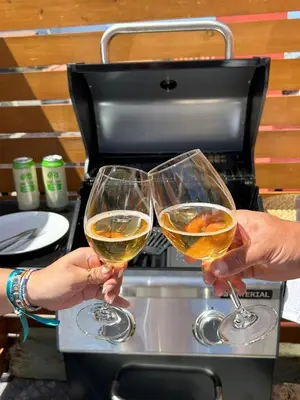two people holding up glasses of white wine at Refúgio do Seixal in Seixal