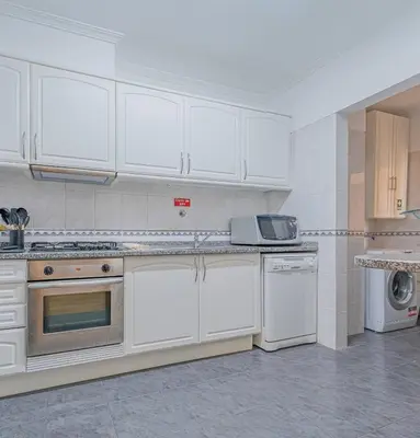a living room with a flat screen tv on a entertainment center at Ocean View Apartment in Caniço de Baixo in Funchal