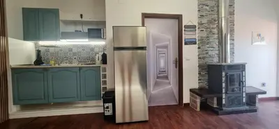a kitchen with a refrigerator and a stove at Casa Monte de Paz in Calheta
