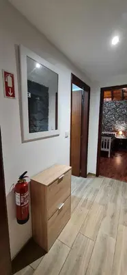 a living room with a dresser and a mirror at Casa Monte de Paz in Calheta
