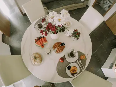 a white table with food and flowers on it at Casa Analino in Feiteiras