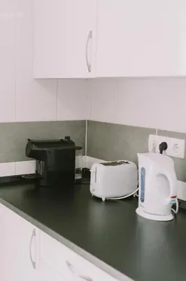 a kitchen counter with a toaster and a toaster and a toaster at Casa Analino in Feiteiras