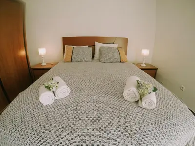 a bed with three rolled up towels on it at Casa Analino in Feiteiras