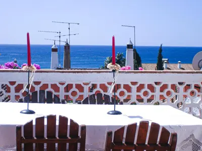 a table with two chairs and the ocean in the background at Beautiful sea view in Luz