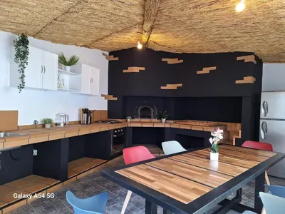 a kitchen and dining room with a table and chairs at Figueira's House By the Atlantic in Ponta do Sol