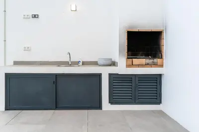 a kitchen with blue cabinets and a sink at Villa Fénix in Câmara de Lobos