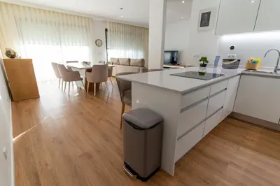 a kitchen and living room with a counter and a table at Villa Fénix in Câmara de Lobos