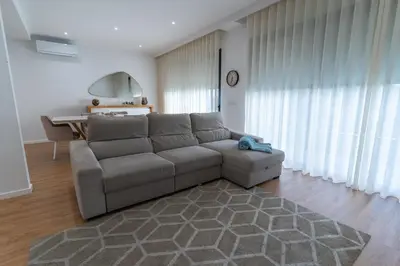a living room with a couch and a table at Villa Fénix in Câmara de Lobos
