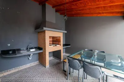 a kitchen with a glass table and a fireplace at Luxury Haven: Heated Pool, AC & Sun in Ponta do Sol