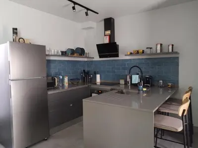 a kitchen with a refrigerator and a counter top at Casa do Favinha in Machico
