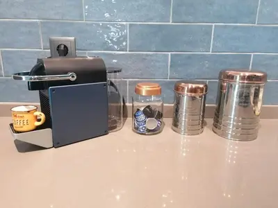 a counter top with a coffee maker and cups at Casa do Favinha in Machico