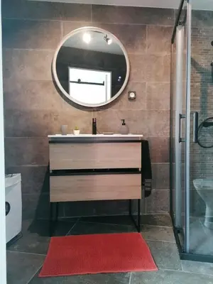 a bathroom with a sink and a mirror at Casa do Favinha in Machico