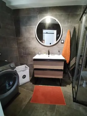 a bathroom with a sink and a mirror at Casa do Favinha in Machico