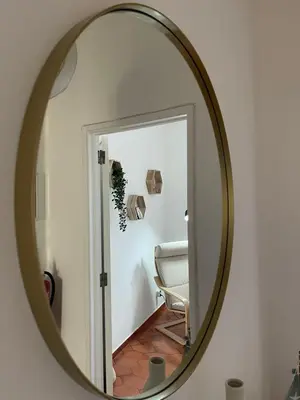 a mirror in a bathroom with a chair in a room at Casa Amar- Vista panorâmica in Luz