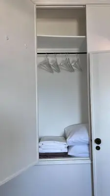 a small closet with hangers and a bed in it at Casa Amar- Vista panorâmica in Luz